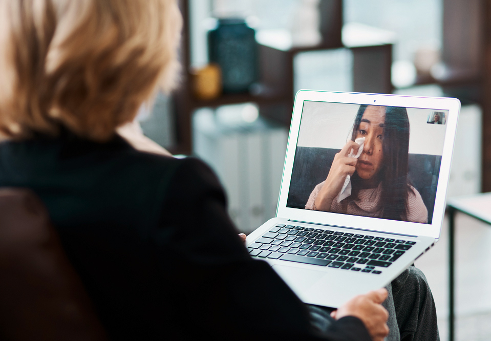 doctor communicating with patient through laptop